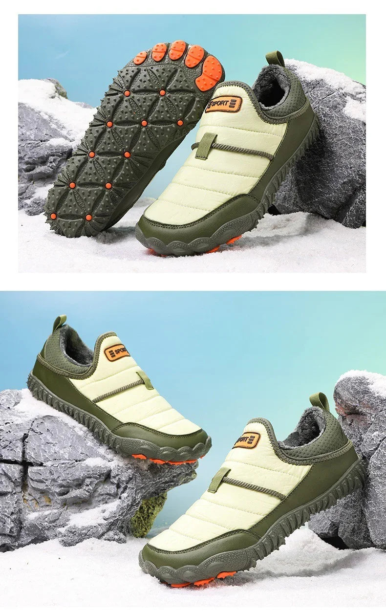 Green and beige winter slip-on hiking shoes with orange grip soles displayed on rocks and snow.