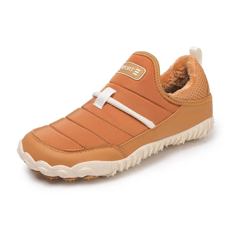Tan slip-on sneaker with faux fur lining, textured sole, and white rope lace detail