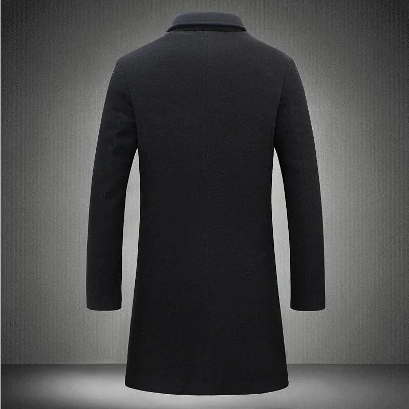 Back view of a black wool overcoat with long sleeves on a grey studio background