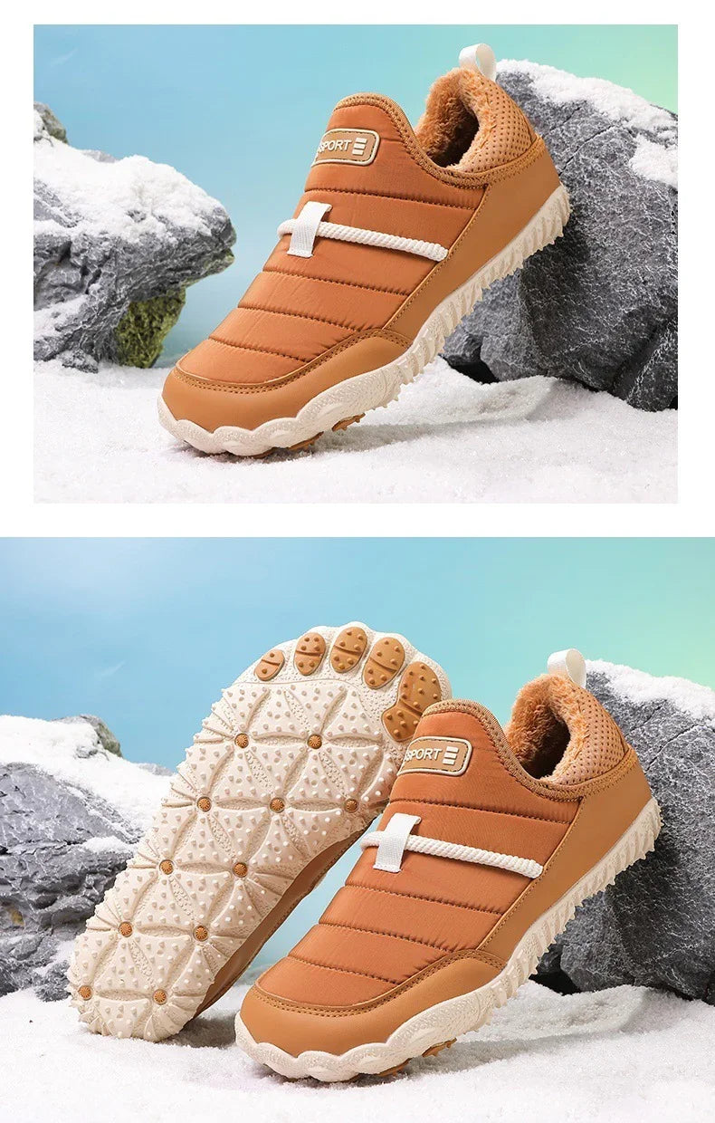 Brown winter slip-on sneakers with white soles and textured grip on snowy outdoor rocks
